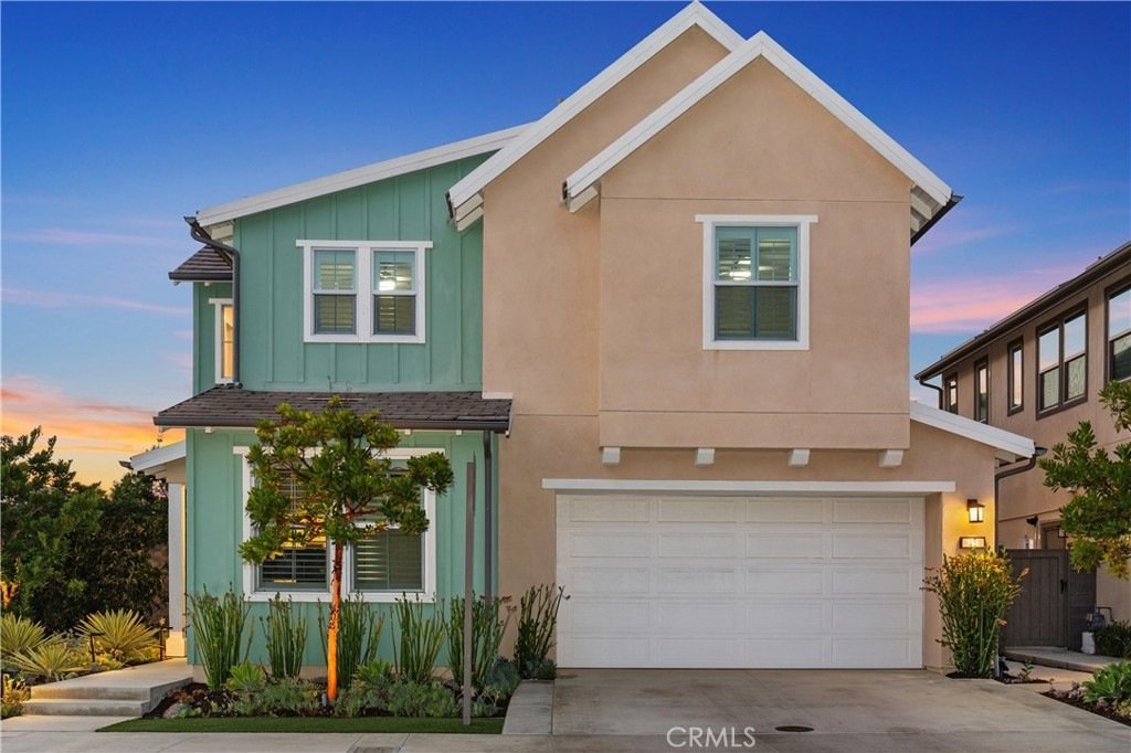 Two-story house on Veraz Rd, Rancho Mission Viejo, CA, with light green and beige siding, white trim, and a garage.