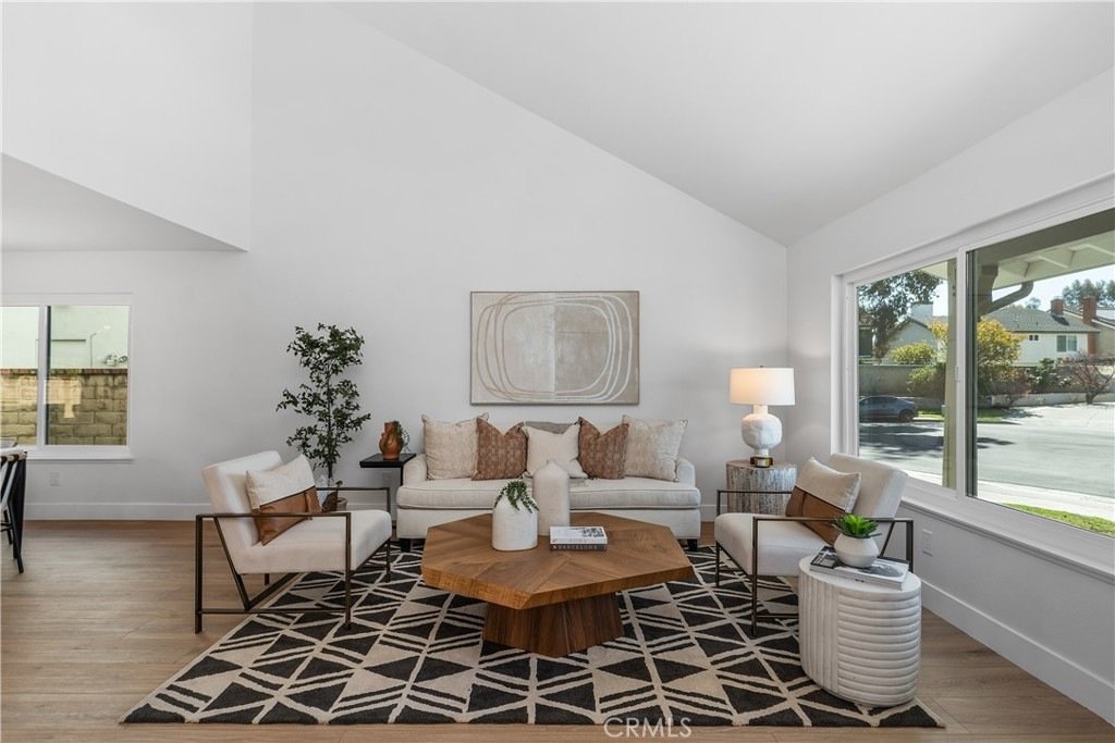 Cozy California living room on Cindy Ln in Lake Forest with a beige sofa, geometric rug, and wooden coffee table.